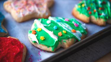 Colourfully frosted sugar cookies on a baking tray