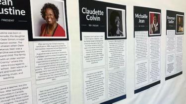 Beige school hallway showing a line of 4 mounted posters with a photo of a black woman on each, with black text on white background below.